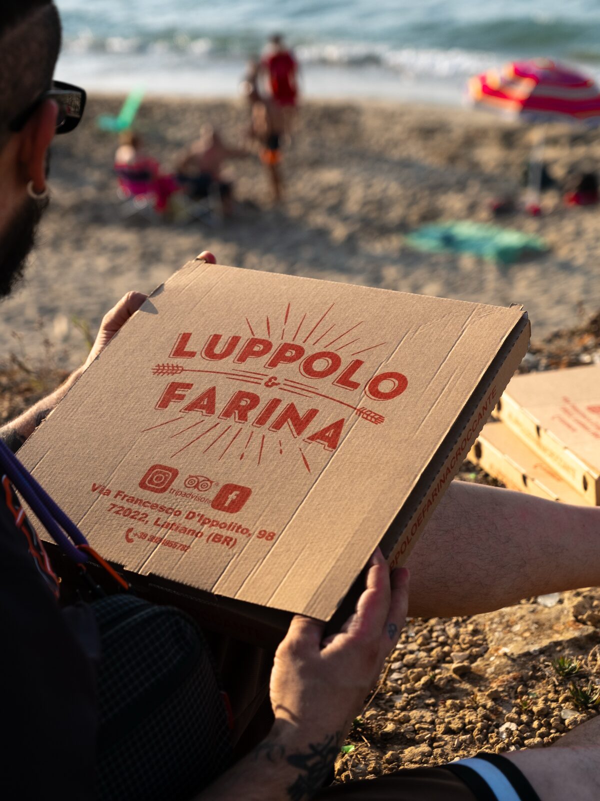 A pizza box on the beach